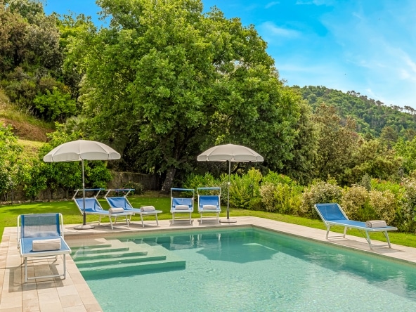 Swimming pool with sun loungers and panoramic terrace.