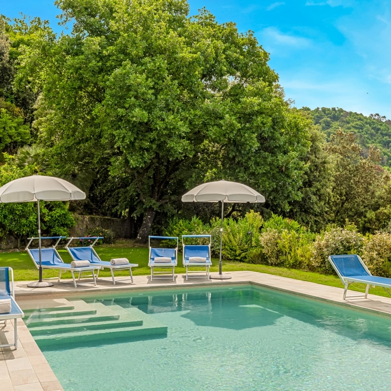 Swimming pool with sun loungers and panoramic terrace.