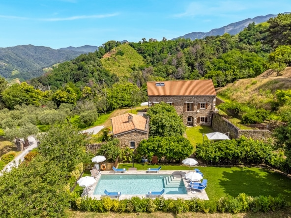 Historic stone façade of Villa Il Convento in Tuscany.