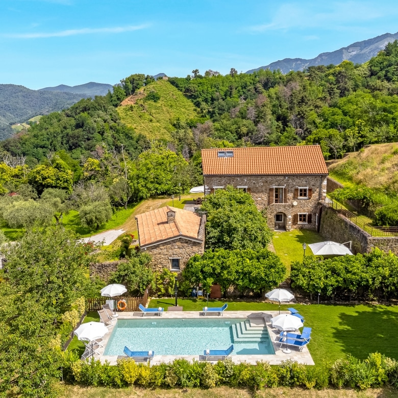 Historic stone façade of Villa Il Convento in Tuscany.